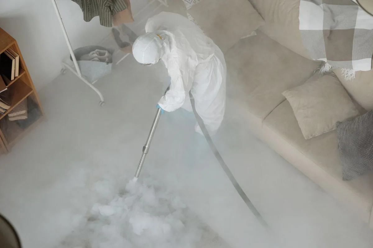 Biohazard cleanup technician in protective equipment, Taylor, TX